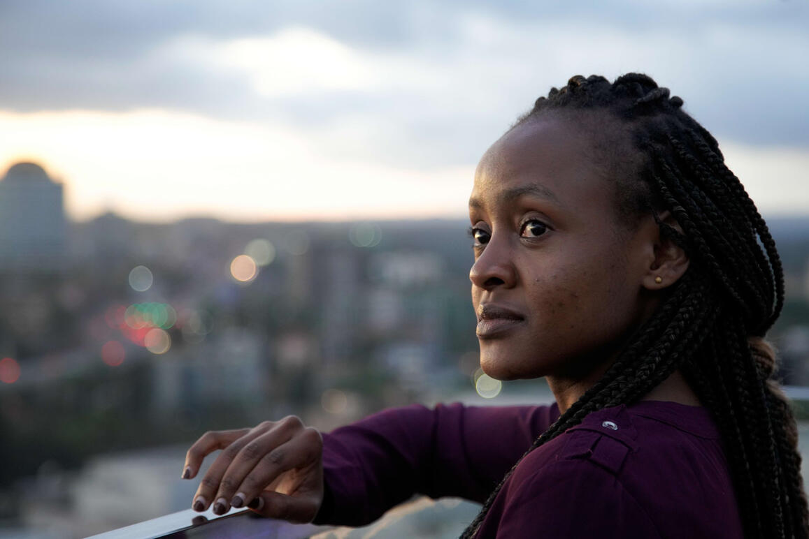 Kenyan Presenter looks out onto cityscape