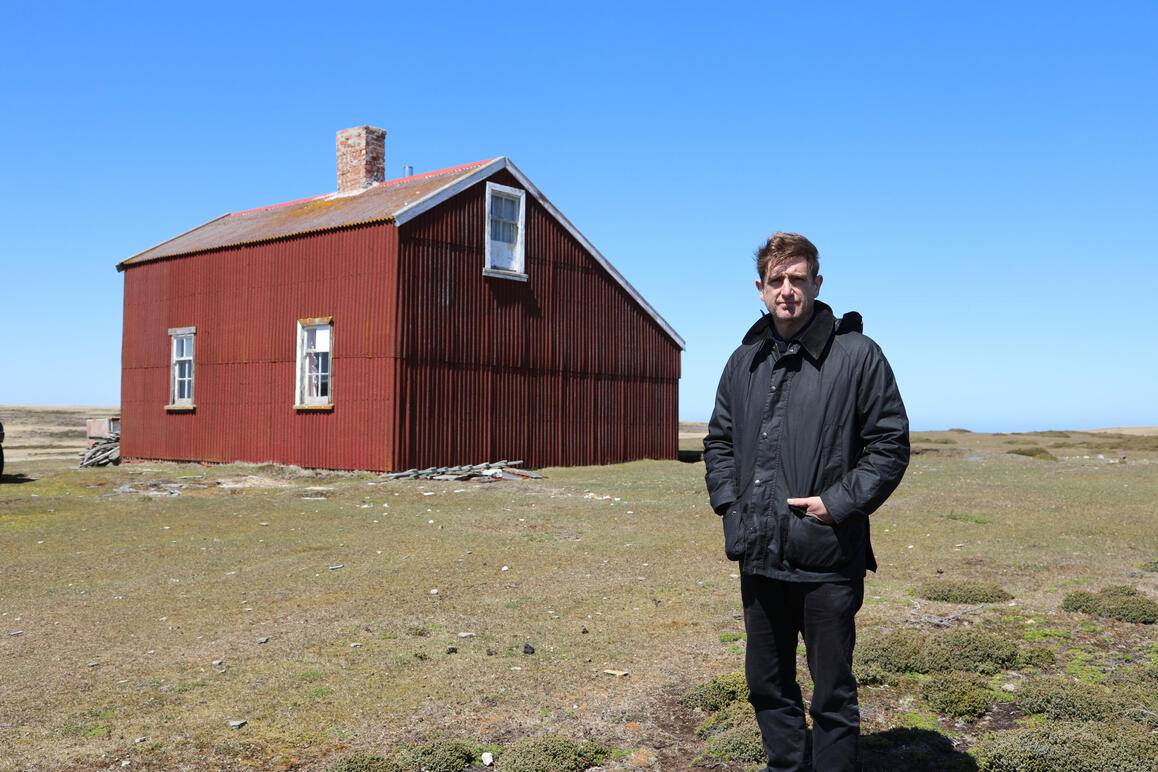 Marcel Theroux stand next to a barn