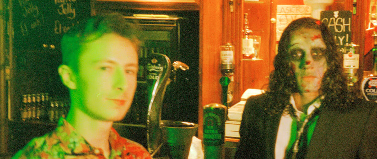 Alex stands next to a zombie